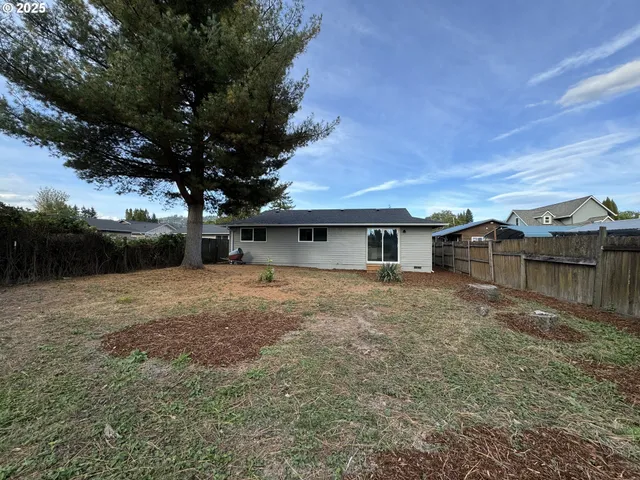 a kitchen with a stove a refrigerator and white cabinets