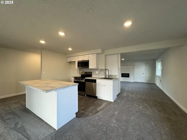 a view of an empty room and a window