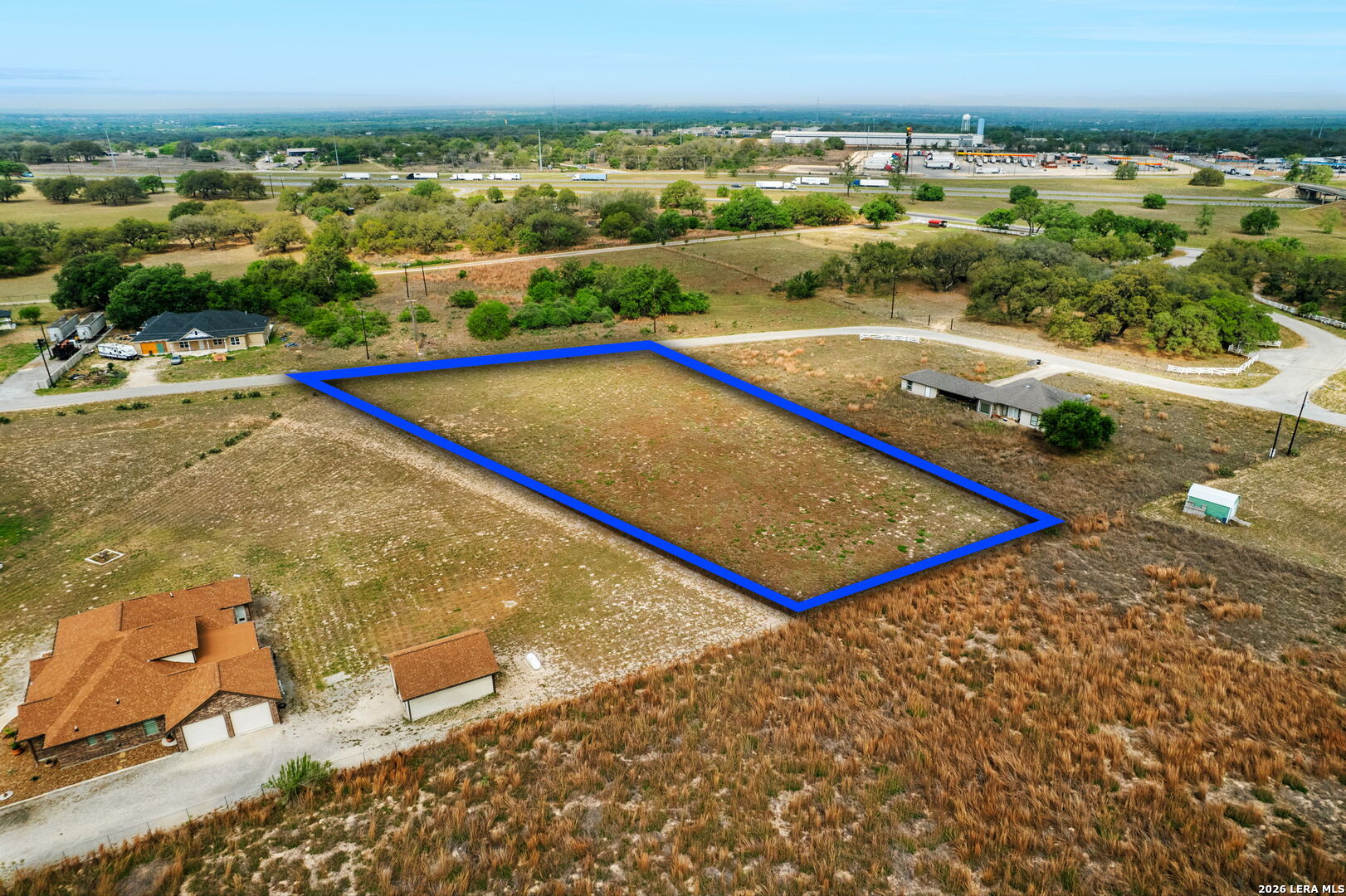 215 Mustang Ridge Natalia, TX 78059 - Photo 4 of 17 a view of a tennis ground with a large pool