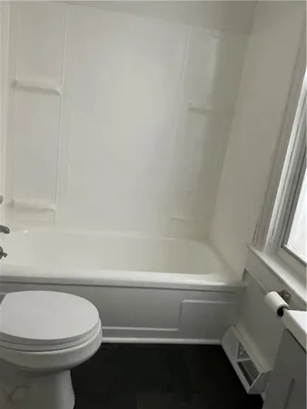 a bathroom with a toilet and a bathtub