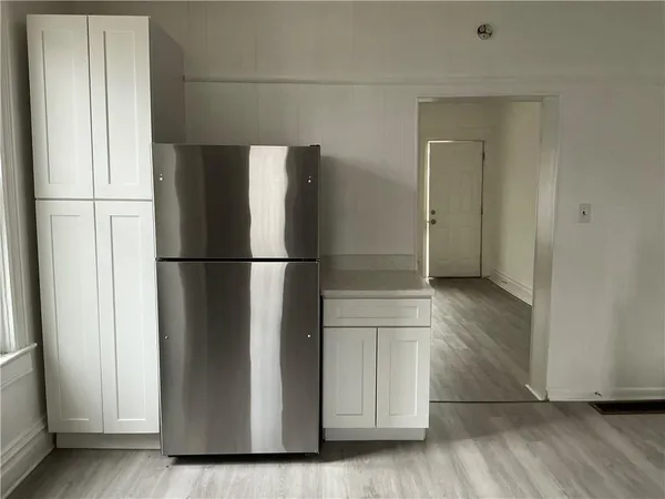 a view of walk in closet with wooden floor