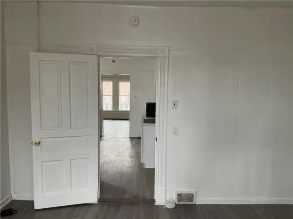 a view of a hallway with wooden floor