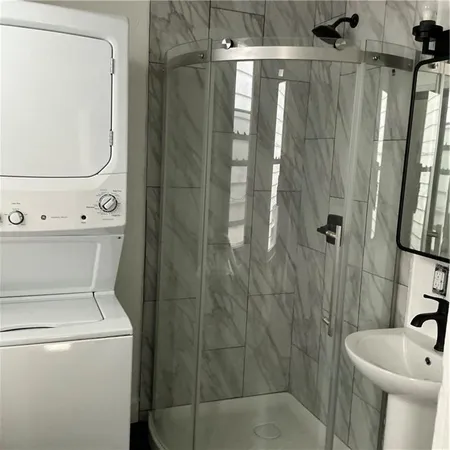 a bathroom with a shower a toilet and a sink