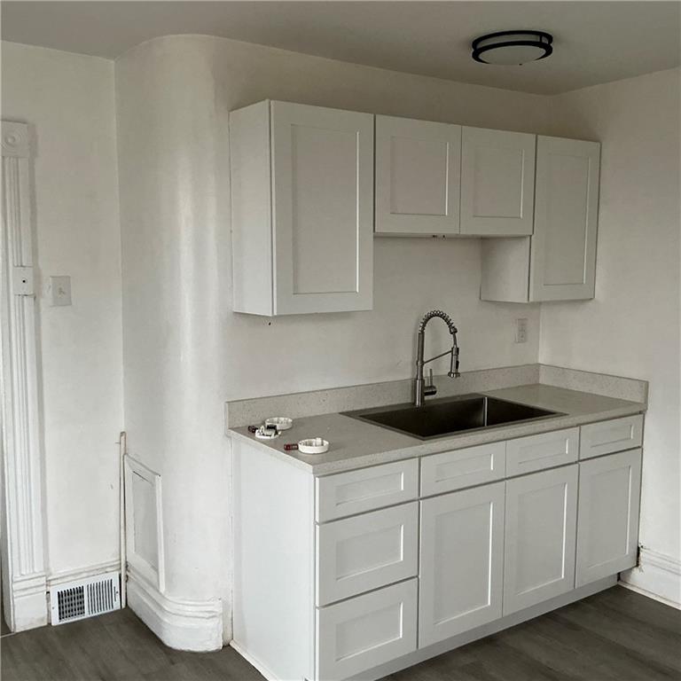 216 Ridge Avenue New Kensington, PA 15068 - Photo 22 of 27 a kitchen with white cabinets and sink