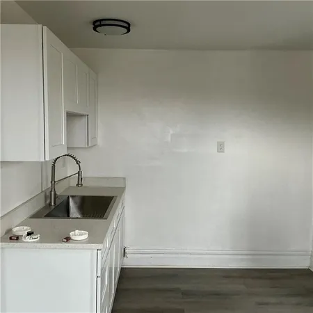a kitchen with a sink a stove and cabinets