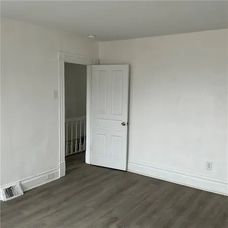 an empty room with wooden floor