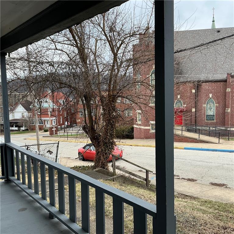 216 Ridge Avenue New Kensington, PA 15068 - Photo 4 of 27 a view of a porch with wooden floor and fence