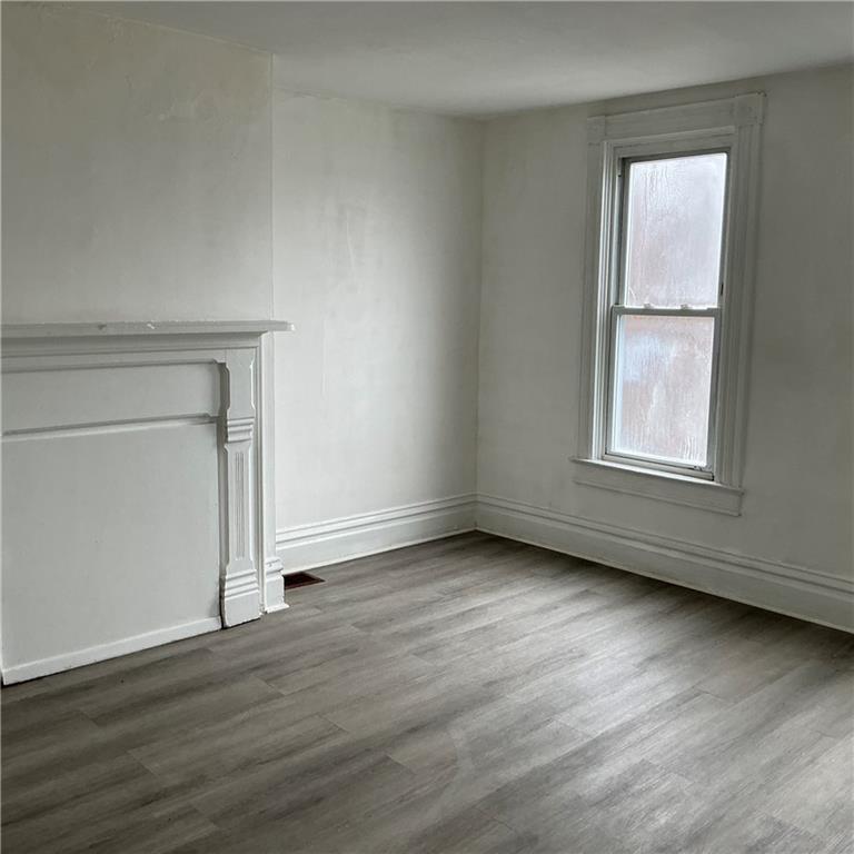 216 Ridge Avenue New Kensington, PA 15068 - Photo 6 of 27 an empty room with wooden floor and windows