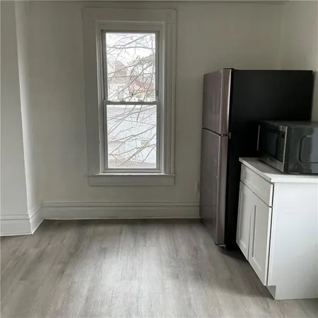 a view of a kitchen with a dishwasher cabinets and a window