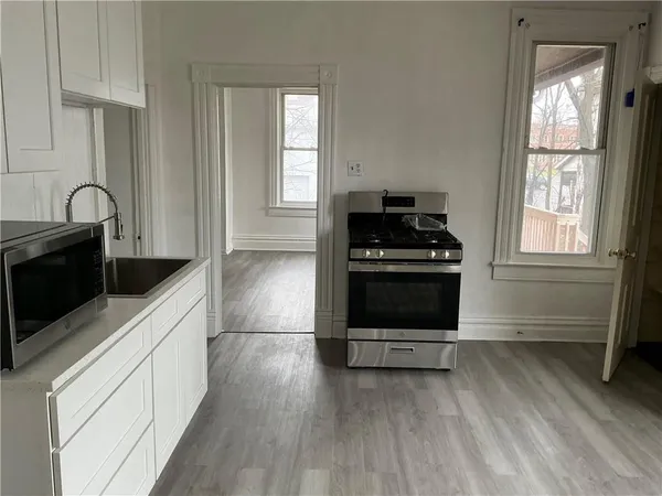 a kitchen with wooden cabinets and a stove top oven