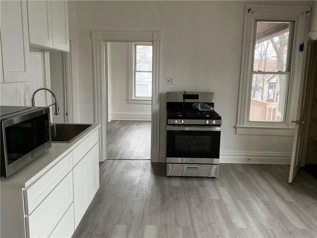 216 Ridge Avenue New Kensington, PA 15068 - Photo 8 of 27 a kitchen with wooden cabinets and a stove top oven
