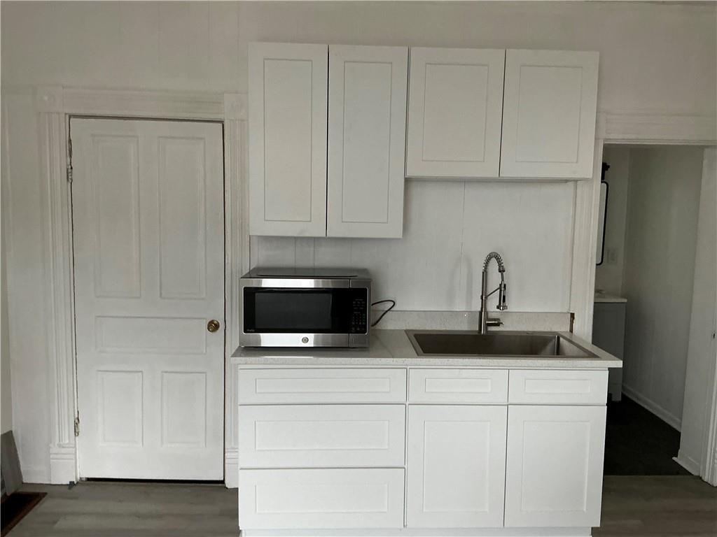216 Ridge Avenue New Kensington, PA 15068 - Photo 9 of 27 a kitchen with stainless steel appliances granite countertop white cabinets and a sink
