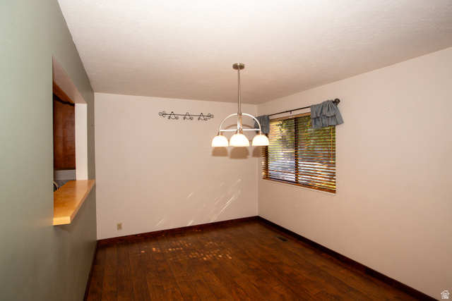 1500 Sumac Drive Logan, UT 84321 - Photo 15 of 42 Wood-finish flooring throughout, featuring a pass-through window with a wood-finish countertop