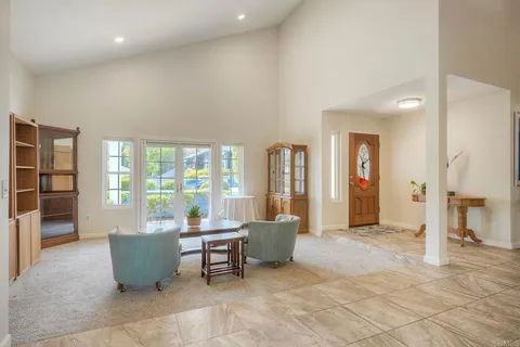 a living room with furniture and large windows