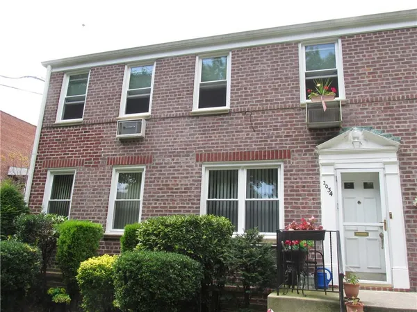 a front view of a house with yard and green space