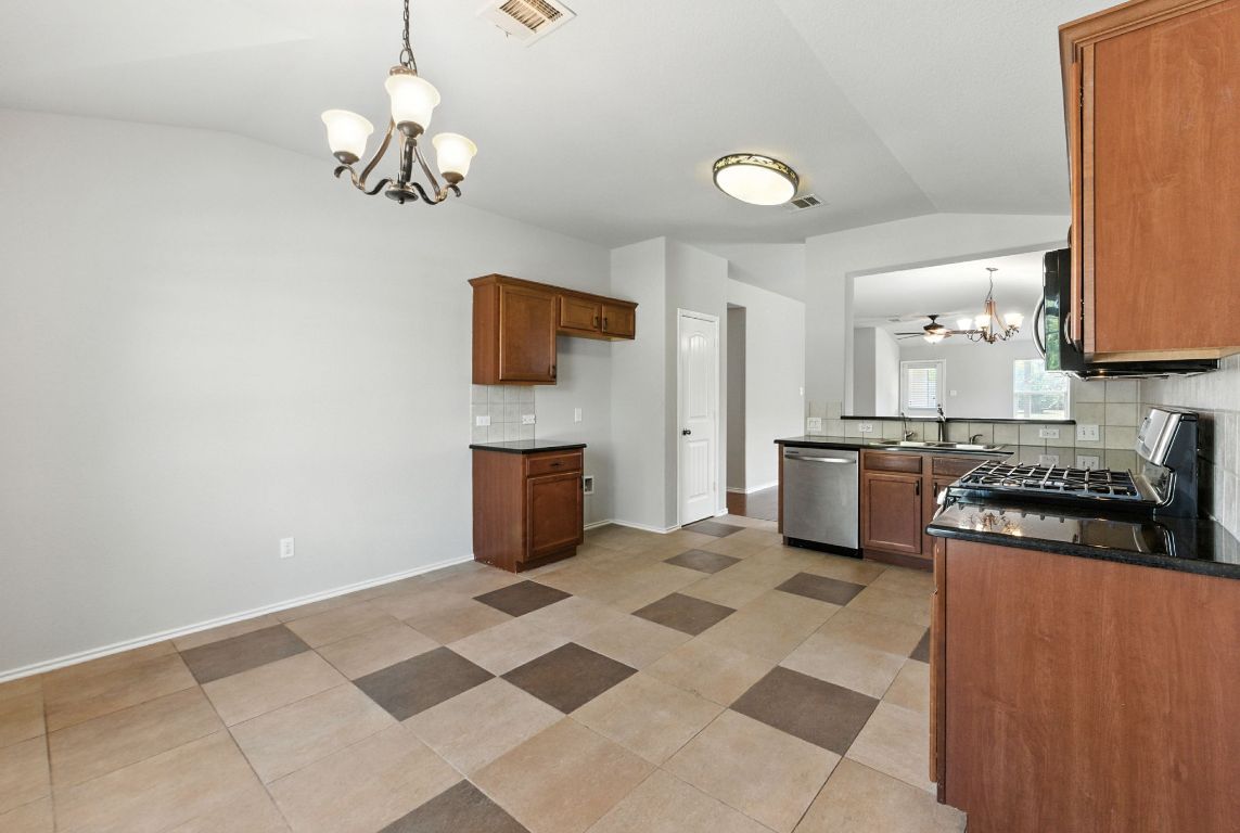 2840 Hearthsong Loop Round Rock, TX 78665 - Photo 11 of 39 a kitchen with stainless steel appliances granite countertop a stove and a sink