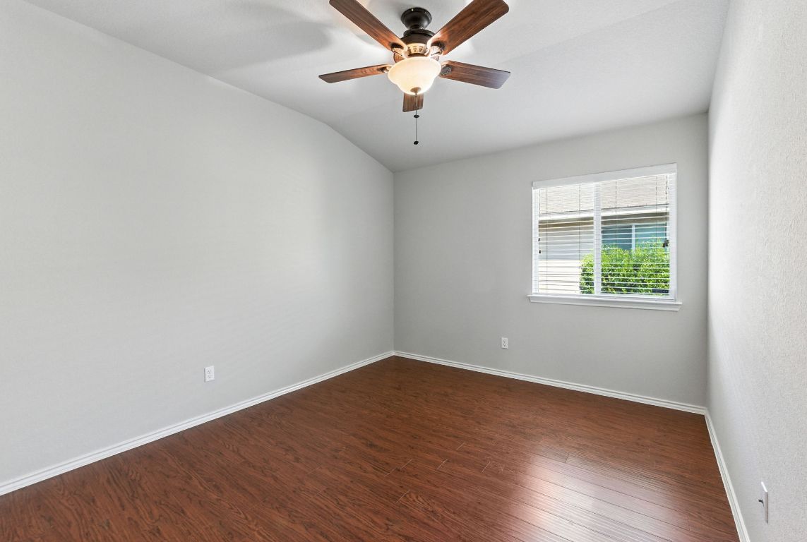 2840 Hearthsong Loop Round Rock, TX 78665 - Photo 15 of 39 wooden floor in an empty room with a window