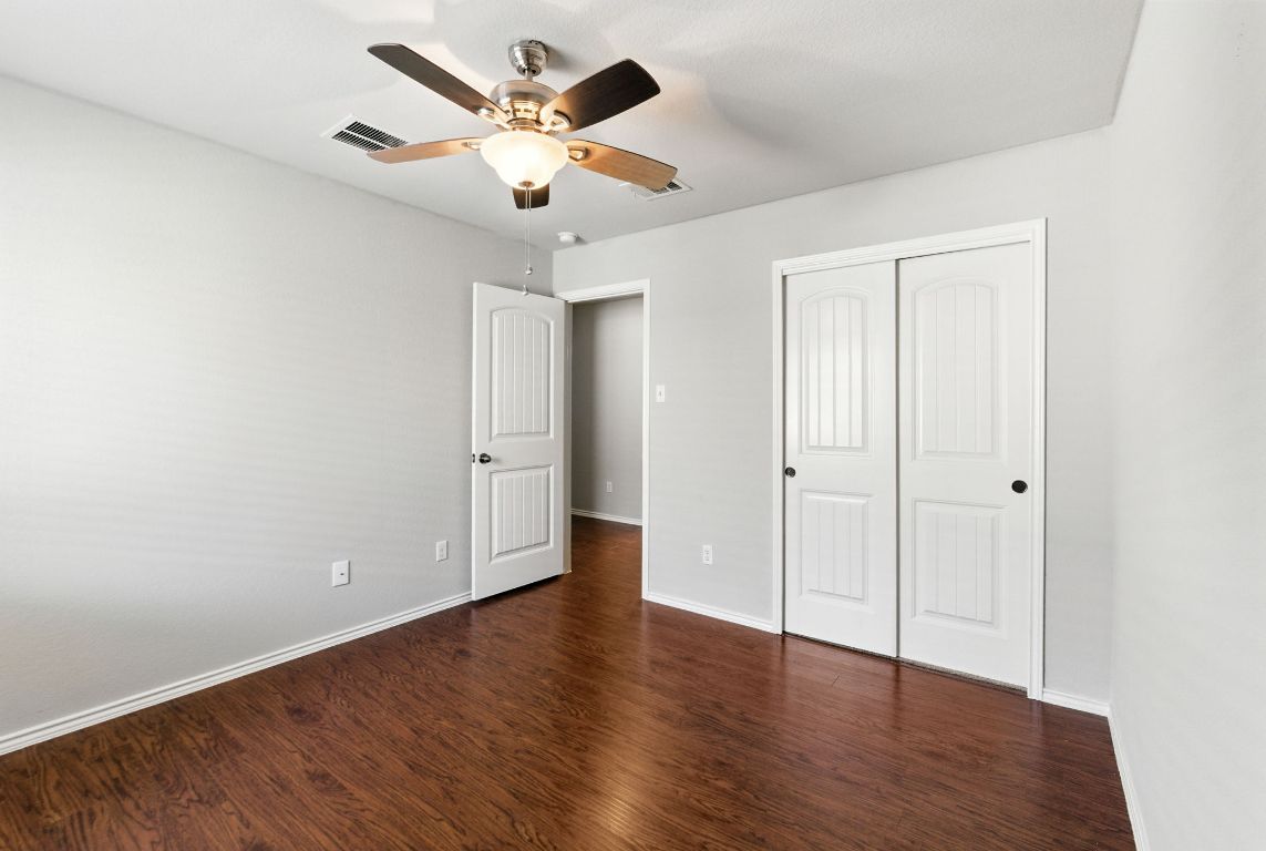 2840 Hearthsong Loop Round Rock, TX 78665 - Photo 18 of 39 an empty room with wooden floor and a ceiling fan