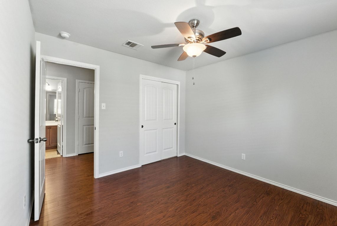 2840 Hearthsong Loop Round Rock, TX 78665 - Photo 20 of 39 wooden floor in an empty room with a window