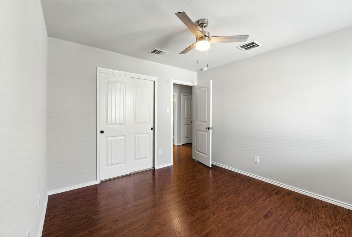 2840 Hearthsong Loop Round Rock, TX 78665 - Photo 22 of 39 an empty room with wooden floor and a ceiling fan