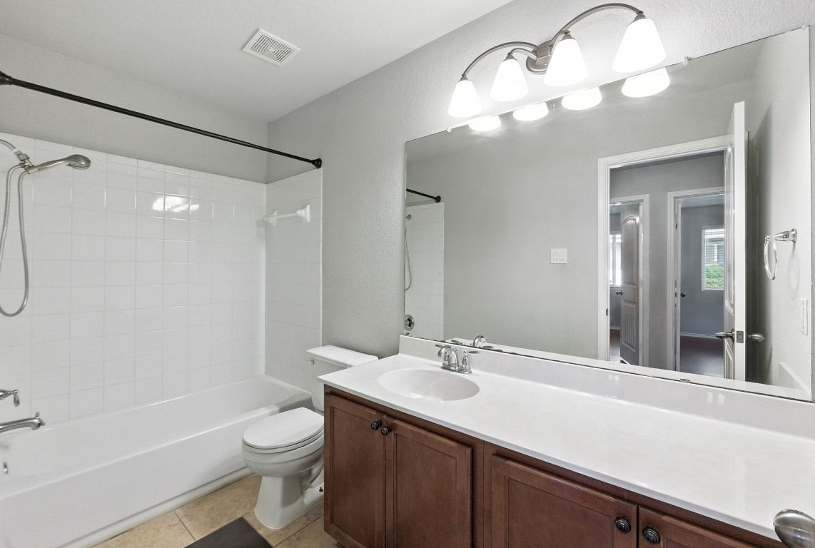 2840 Hearthsong Loop Round Rock, TX 78665 - Photo 24 of 39 a bathroom with a sink a toilet and a large mirror