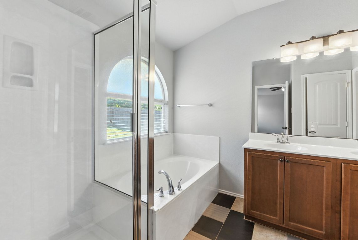 2840 Hearthsong Loop Round Rock, TX 78665 - Photo 28 of 39 a bathroom with a tub sink and mirror