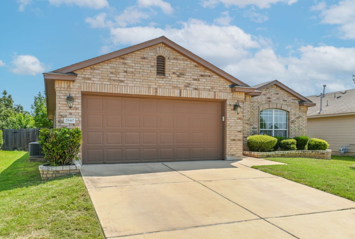2840 Hearthsong Loop Round Rock, TX 78665 - Photo 3 of 39 a front view of a house with garden