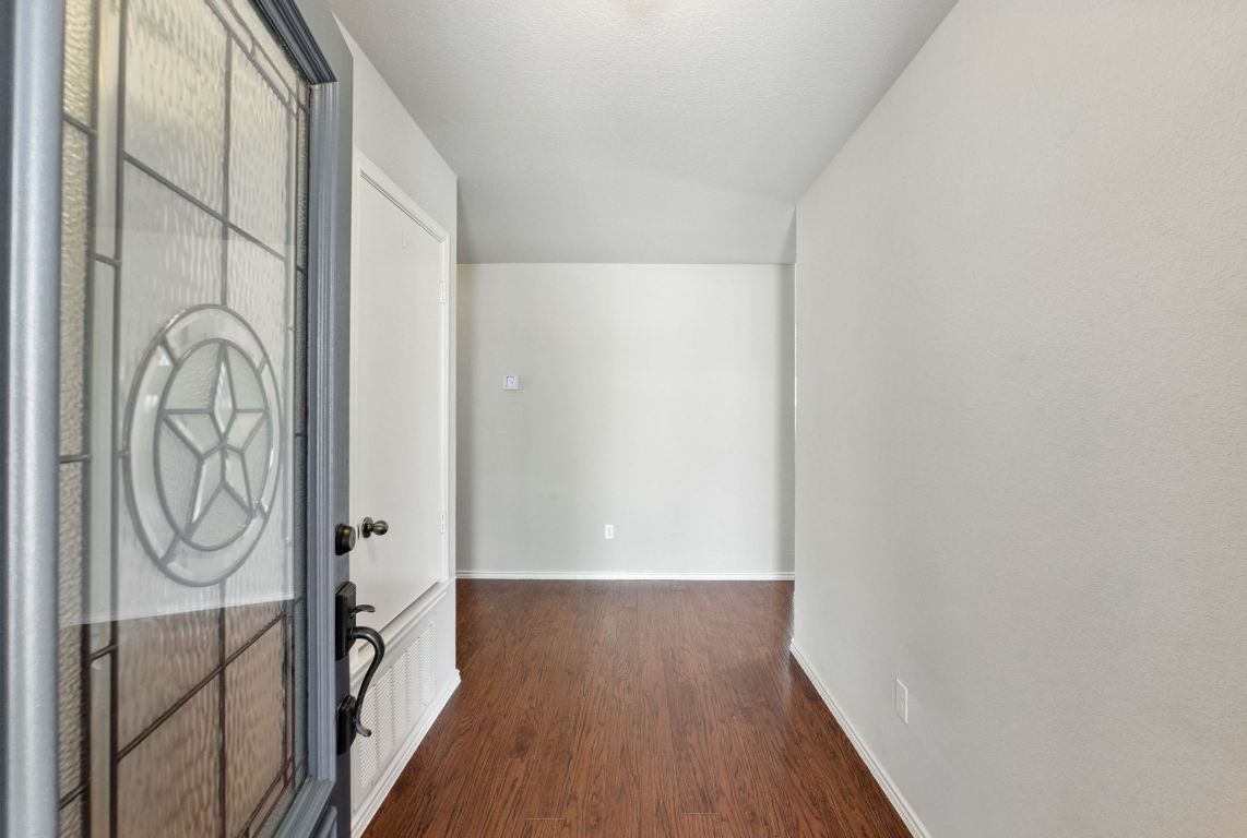 2840 Hearthsong Loop Round Rock, TX 78665 - Photo 4 of 39 a view of a hallway with wooden floor