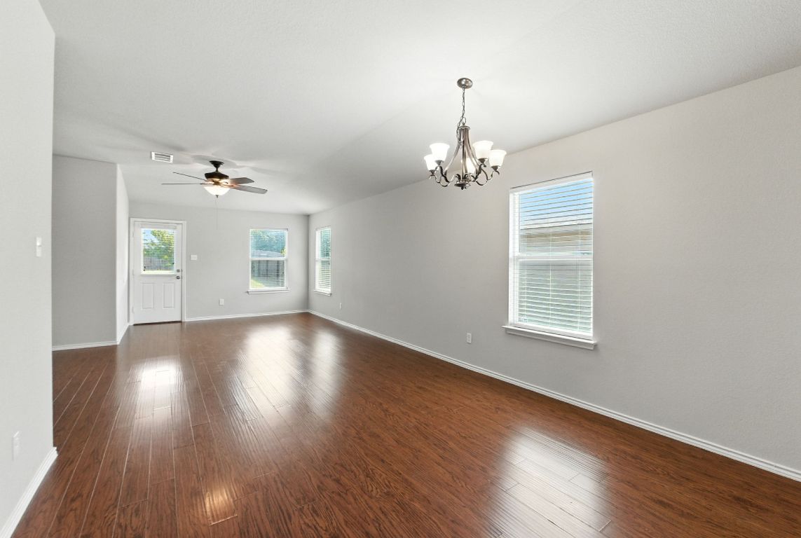 2840 Hearthsong Loop Round Rock, TX 78665 - Photo 5 of 39 a view of an empty room with wooden floor and a window