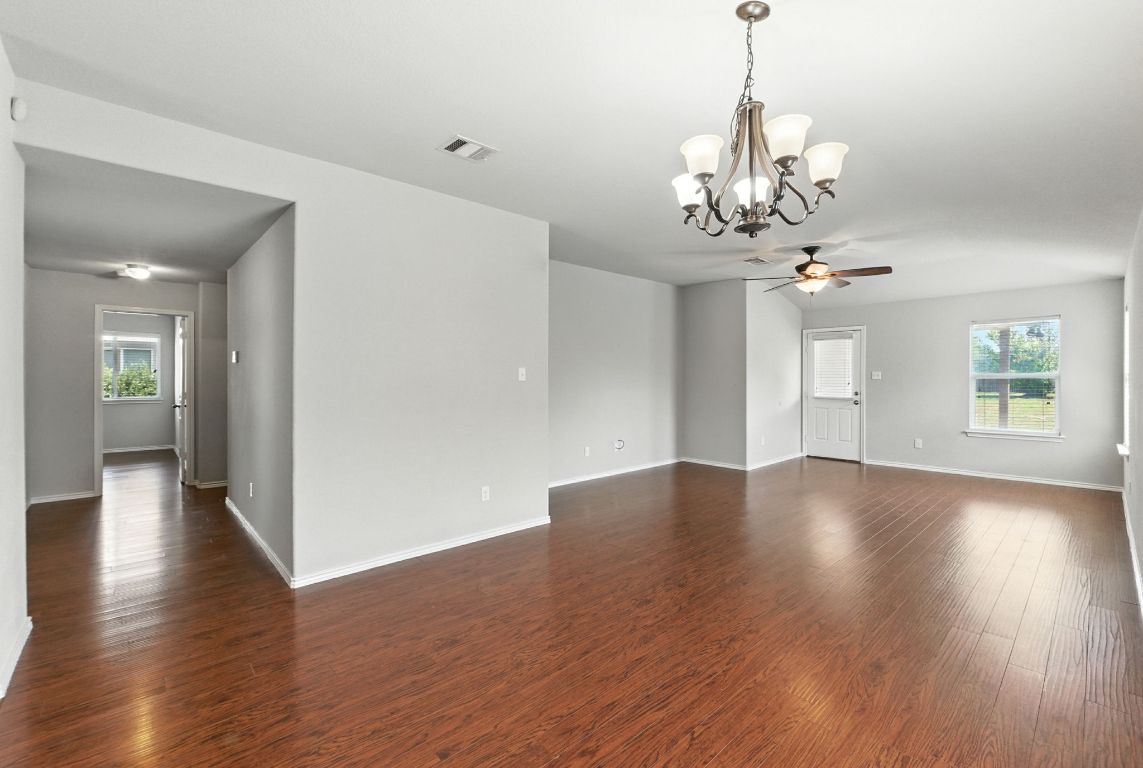 2840 Hearthsong Loop Round Rock, TX 78665 - Photo 6 of 39 a view of a livingroom with wooden floor and a chandelier