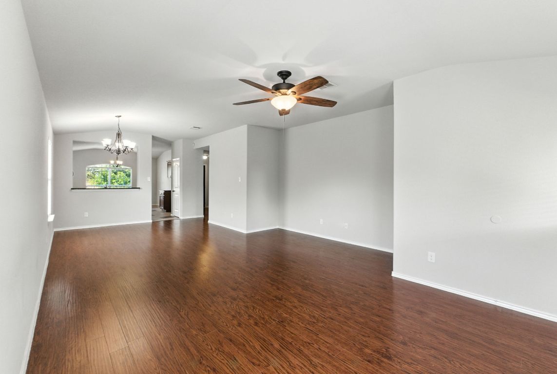2840 Hearthsong Loop Round Rock, TX 78665 - Photo 7 of 39 a view of an empty room with window and wooden floor