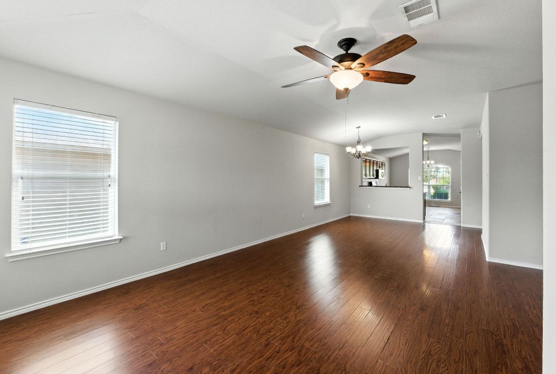 2840 Hearthsong Loop Round Rock, TX 78665 - Photo 8 of 39 a view of an empty room with wooden floor and a window