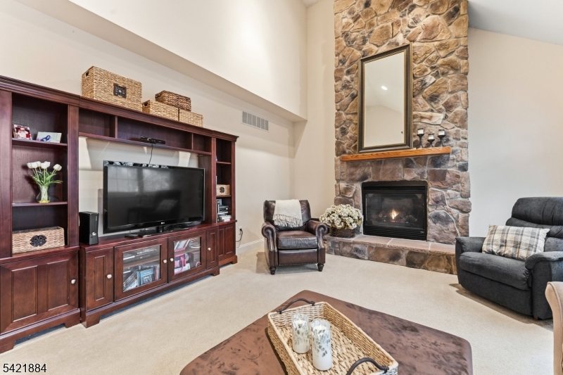 26 Rouser Way Hillsborough, NJ 08844 - Photo 20 of 49 a living room with furniture and a flat screen tv