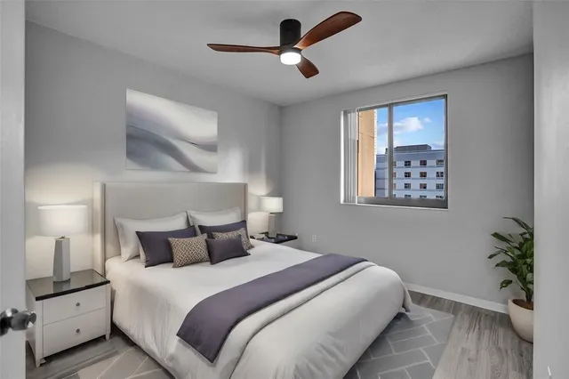 a bedroom with a bed and a potted plant