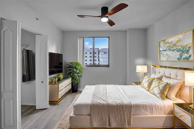 a bedroom with a bed and a flat screen tv