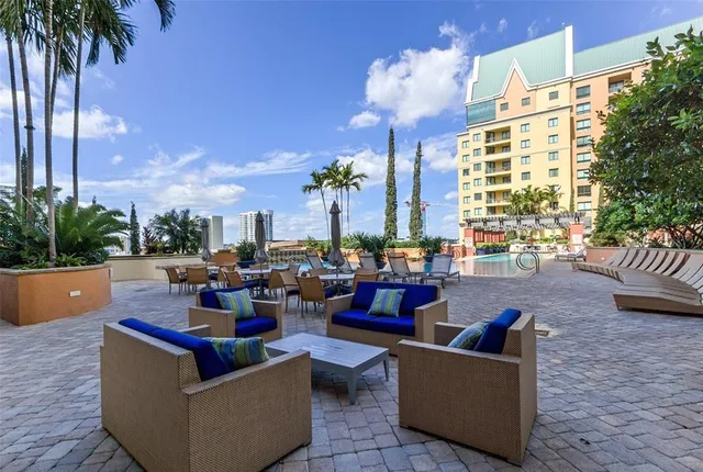 a living room with couches and a potted plant