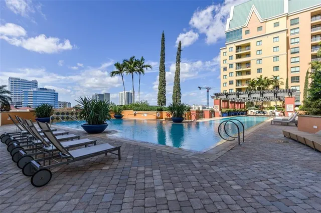 a view of swimming pool with outdoor seating and plants