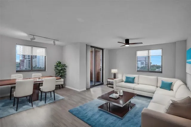 a living room with furniture and a potted plant
