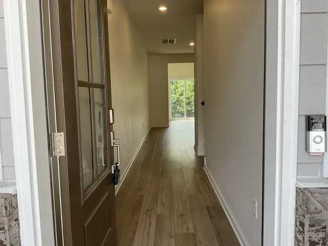 a view of a kitchen with a white cabinet and a stove top oven