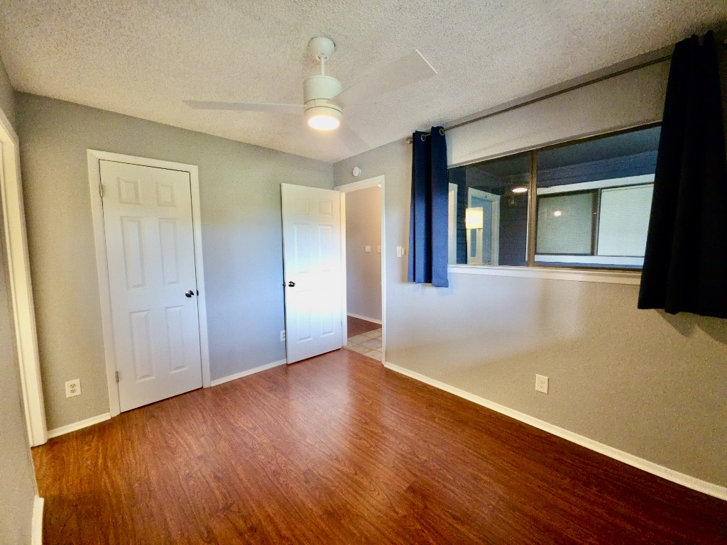 2500 Burleson Road, Unit 521 Austin, TX 78741 - Photo 16 of 20 Room featuring wood-finish flooring, light grey walls, and white trim