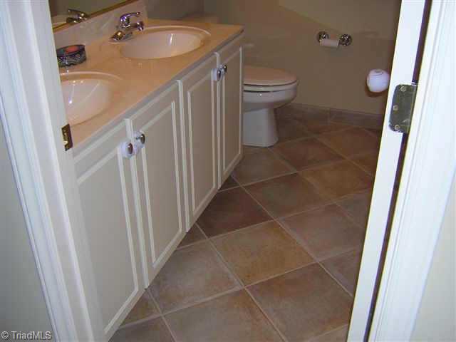 Other. Guest bath with cultured double vanity & exquisite Italian tile.