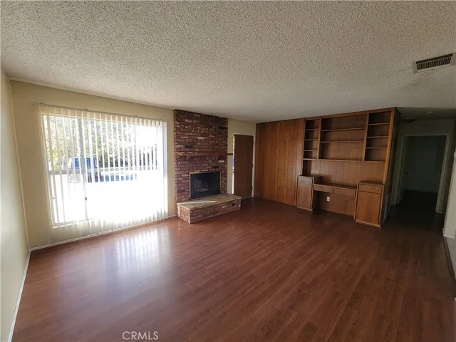 an empty room with furniture and wooden floor