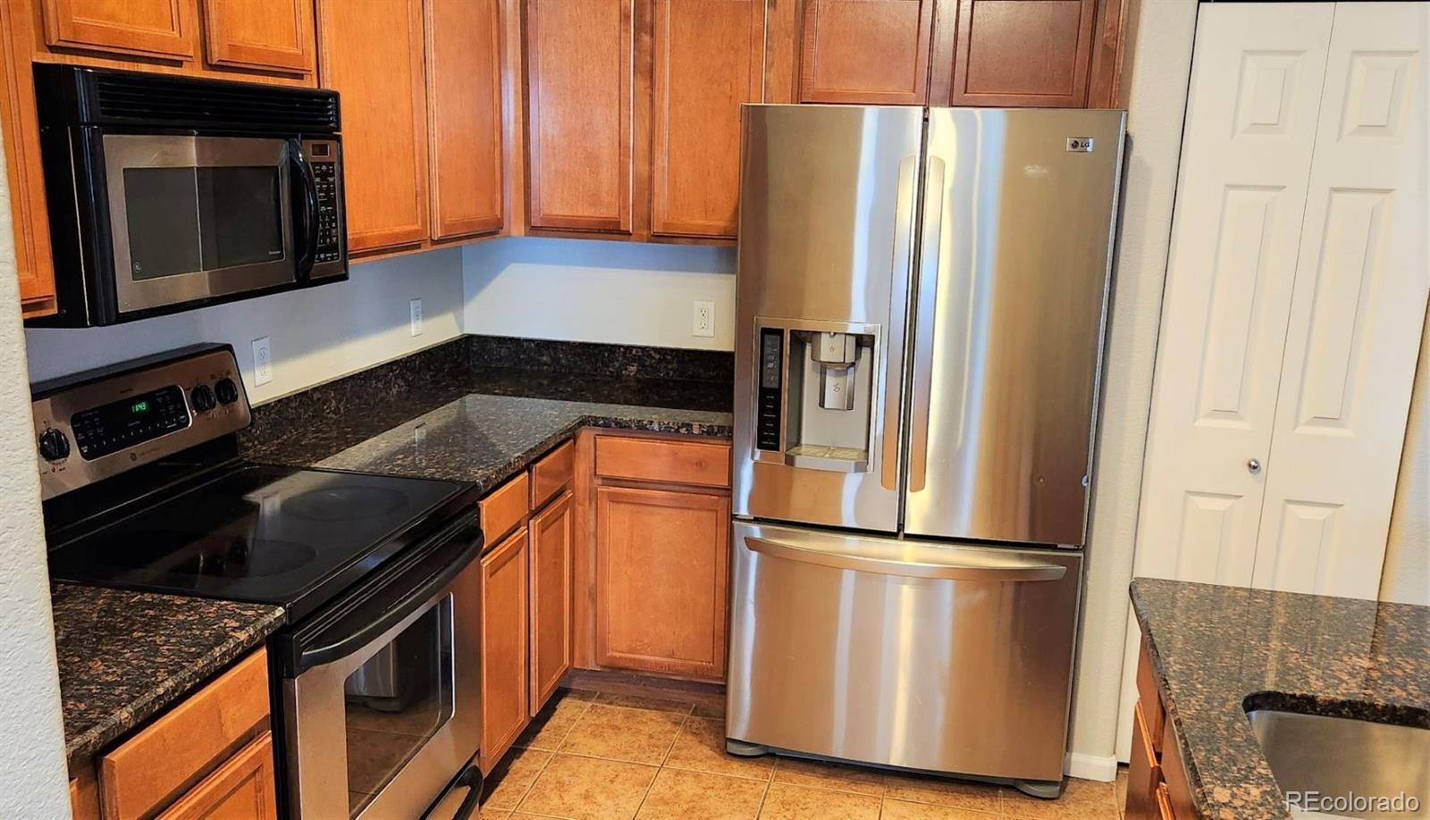10787 Twenty Mile Road, Unit 305 Parker, CO 80134 - Photo 14 of 28 a kitchen with a refrigerator stove and microwave