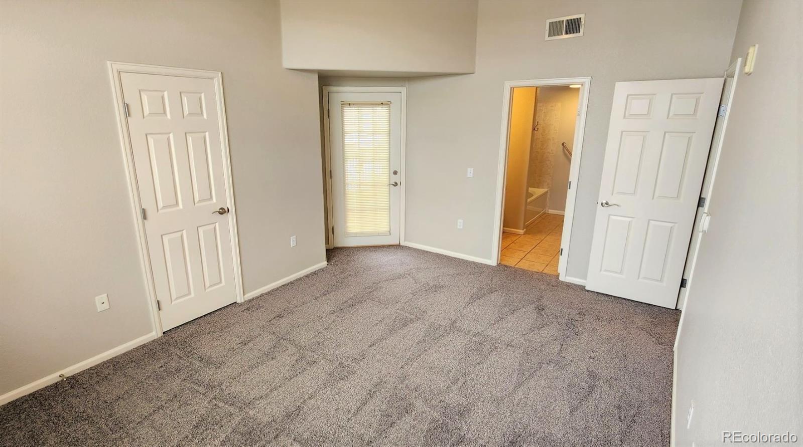 10787 Twenty Mile Road, Unit 305 Parker, CO 80134 - Photo 22 of 28 an empty room with windows and closet