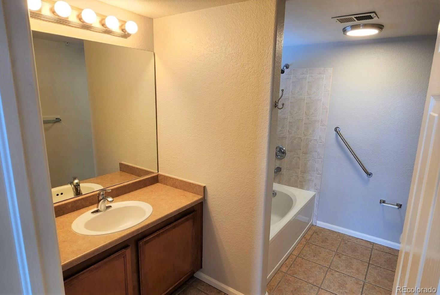 10787 Twenty Mile Road, Unit 305 Parker, CO 80134 - Photo 25 of 28 a bathroom with a sink and a mirror