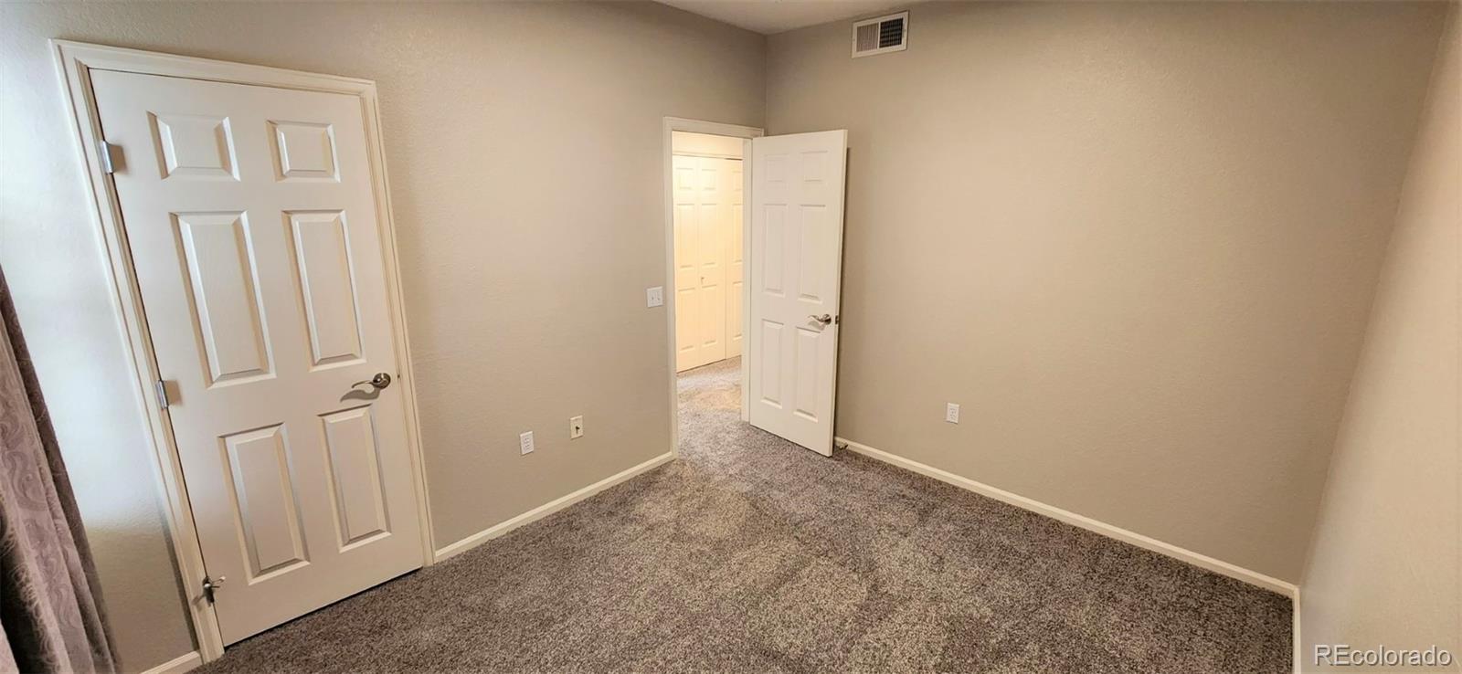10787 Twenty Mile Road, Unit 305 Parker, CO 80134 - Photo 26 of 28 an empty room with windows
