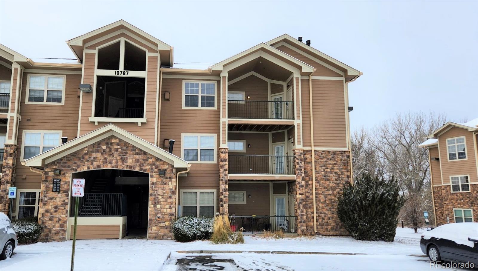 10787 Twenty Mile Road, Unit 305 Parker, CO 80134 - Photo 4 of 28 a front view of a house with a yard