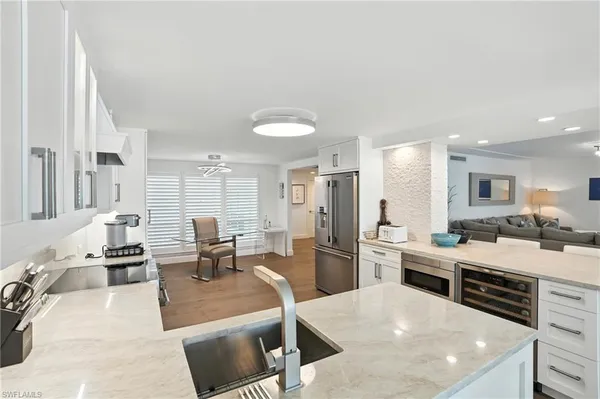 a kitchen with white cabinets and white appliances