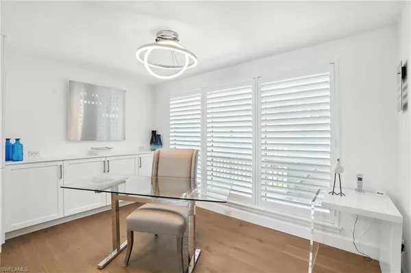 a bedroom with a white bed and a chandelier