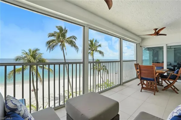 a balcony with table and chairs